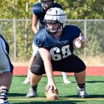 Senior Tony McDaniel gets set to hike the ball during lineman drills at Glacier Peak High School on Tuesday, Aug. 27. (Katie Webber / The Herald)