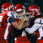 Marysville-Pilchucks Nate Elwood (left) and Zion Botelho (right) celebrates Edgar Martinez (center) game tying field goal to force overtime against Prairie Friday evening at Quil Ceda Stadium in Marysville on November 15, 2019. Marysville-Pilchuck won 37-30 in overtime. (Kevin Clark / The Herald)