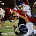 Snohomishs Tyler Larson stretches for extra yards with Meadowdales defense Friday evening at Veterans Memorial Stadium in Snohomish on October 25, 2019. (Kevin Clark / The Herald)