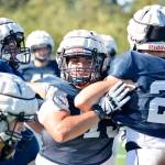 Senior Mason Bridges pushes past the offense during defensive dirlls at Glacier Peak High School on Tuesday, Aug. 27. (Katie Webber / The Herald)