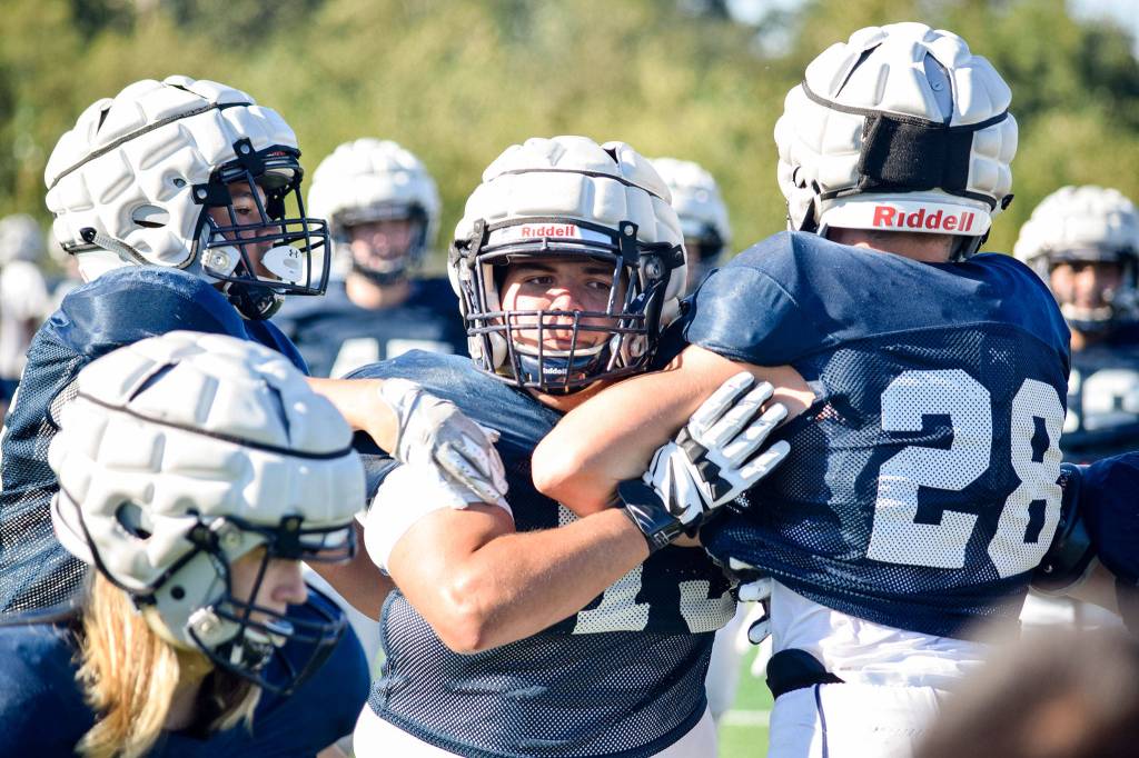 Senior Mason Bridges pushes past the offense during defensive dirlls at Glacier Peak High School on Tuesday, Aug. 27. (Katie Webber / The Herald)