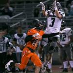 Mount Vernons Carlos Garcia jumps for a reception with Monroes Jonathan Yates defending Friday night at Monroe High School in Monroe on September 28, 2018. (Kevin Clark / The Herald)