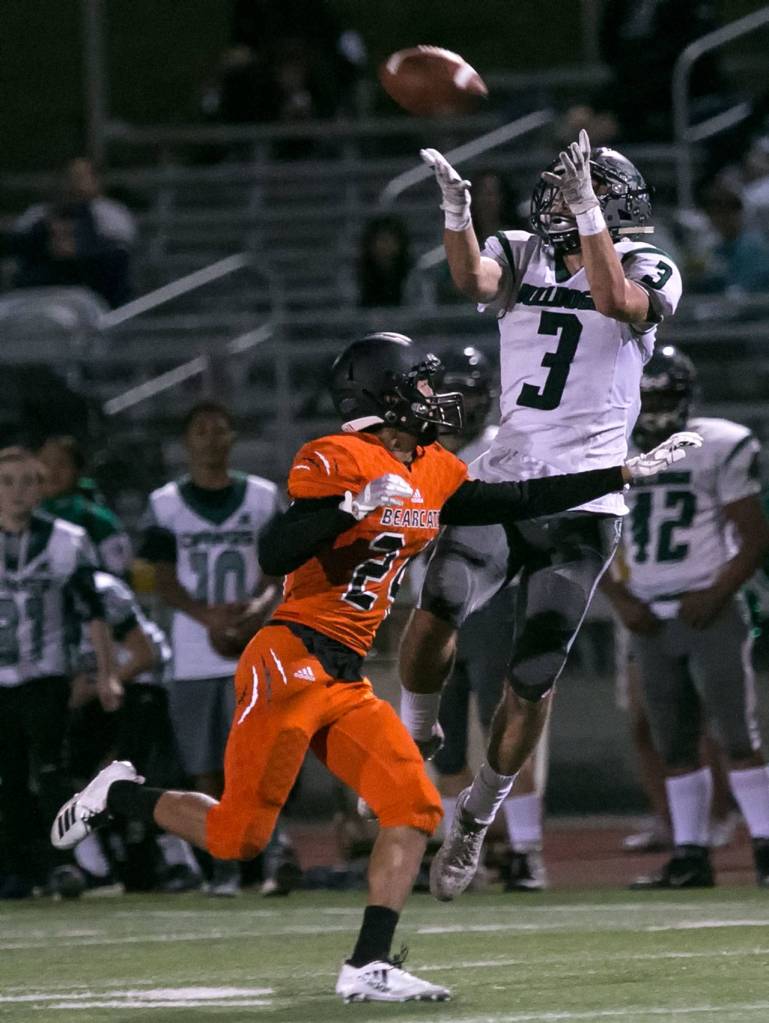 Mount Vernons Carlos Garcia jumps for a reception with Monroes Jonathan Yates defending Friday night at Monroe High School in Monroe on September 28, 2018. (Kevin Clark / The Herald)