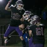 Lake Stevens Joe Gonzales (left) celebrates with Mason Gack (right) Jackson Grafes (center) touchdown Friday night at Lake Stevens High School on October 5, 2018. (Kevin Clark / The Herald)