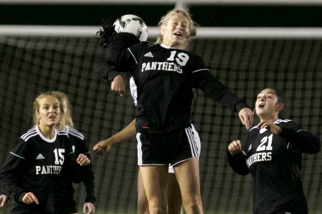 Snohomishs Gracie Winders jumps for a header Wednesday night during the first-round of the 3A state playoff at Veterans Memorial High School in Snohomish on November 7, 2018. (Kevin Clark / The Herald)