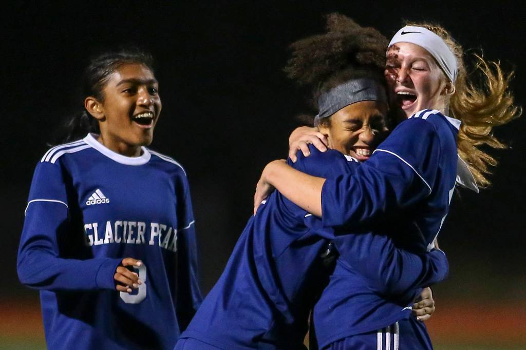 Glacier Peaks Aaliyah Collins celebrates her goal with Kate Sprink (right) with Abigail Varghese (left) looking on Tuesday night at Glacier Peak High School in Snohomish on September 24, 2019. Glacier Peak won 5-1. (Kevin Clark / The Herald)
