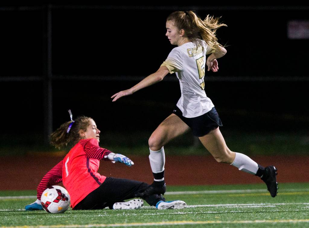 Marysville-Getchells Jadin Thompson-Sheldon dribbles past Edmonds-Woodways goalkeeper Jessica Emerson to score during the district semifinal game on Nov. 5, 2019 in Edmonds, Wash. (Olivia Vanni / The Herald)