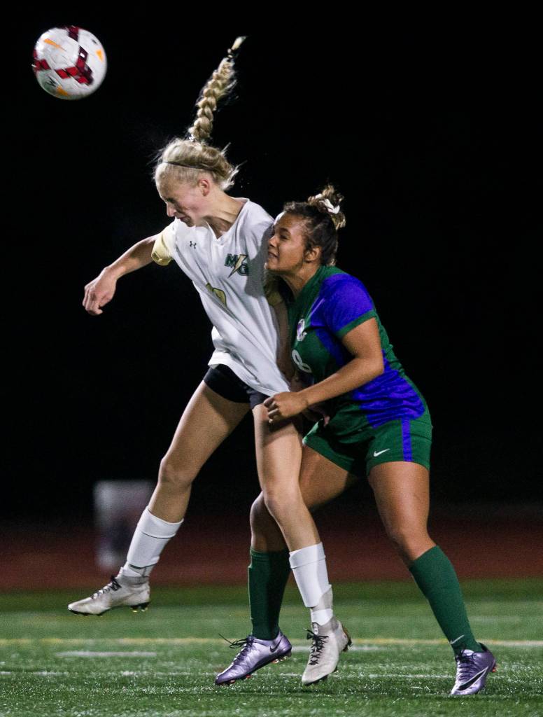 Edmonds-Woodways Sophia Martino-Crew pulls on Marysville-Getchells Kirsten Cranes jersey as she jump up for the ball at during the district semifinal game on Nov. 5, 2019 in Edmonds, Wash. (Olivia Vanni / The Herald)