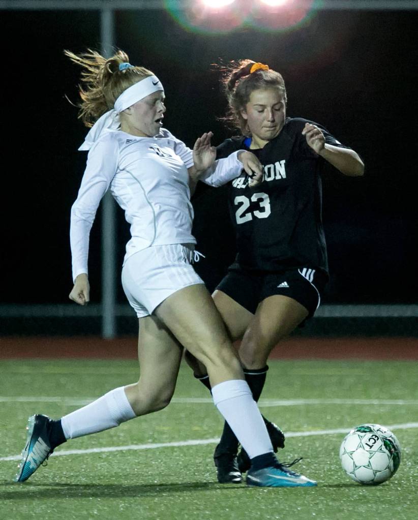 Lake Stevens Mackenzie Delgado (left) and Jacksons Gabriela Franco vie control Thursday night at Everett Memorial Stadium on October 25, 2018. (Kevin Clark / The Herald)