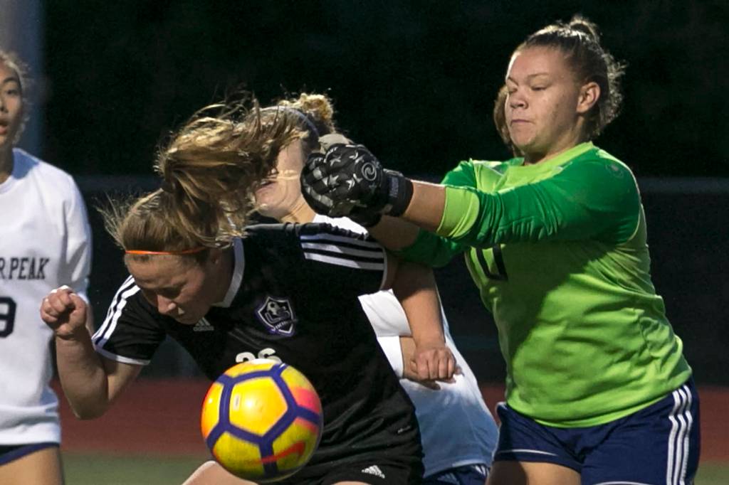 Lake Stevens Kelsey Brace (left) heads the ball with Glacier Peaks Neomi MacMillan defending Tuesday night at Lake Stevens High School in Lake Stevens on September 11, 2018. (Kevin Clark / The Herald)