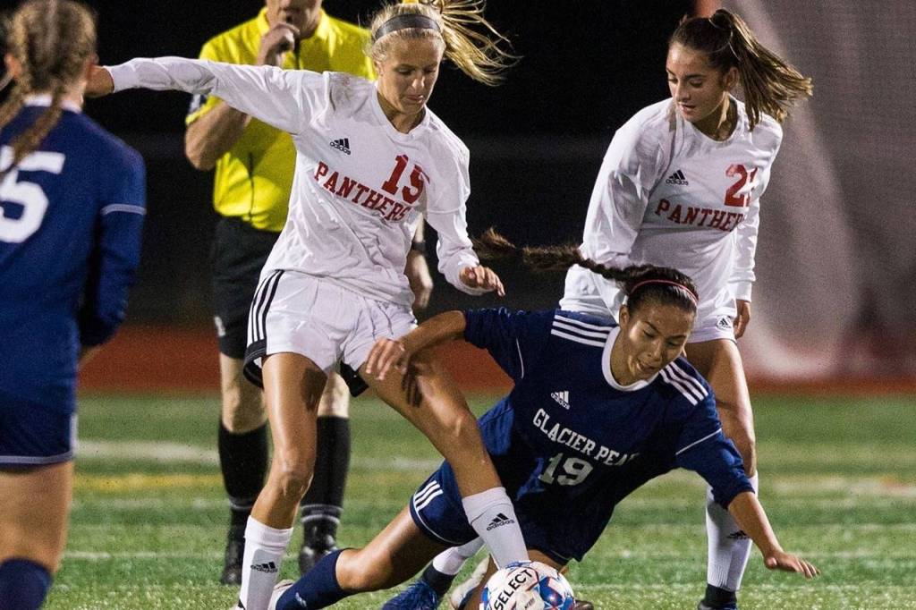 Snohomishs Kayla Soderstorm and Ravyn Mummey trip up Glacier Peaks Emily Strong during the game on Tuesday, Sept. 10, 2019 in Snohomish, Wash. (Olivia Vanni / The Herald)