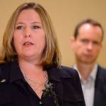 Jill McCluskey speaks at a news conference in Salt Lake City on Monday. Jill and Matthew McCluskey, back right, parents of Lauren McCluskey, a University of Utah student and track athlete from Pullman who was fatally shot on campus, are fighting a claim by the college that their lawsuit should be dismissed because their daughters killer wasnt a student. (Trent Nelson/The Salt Lake Tribune via AP)
