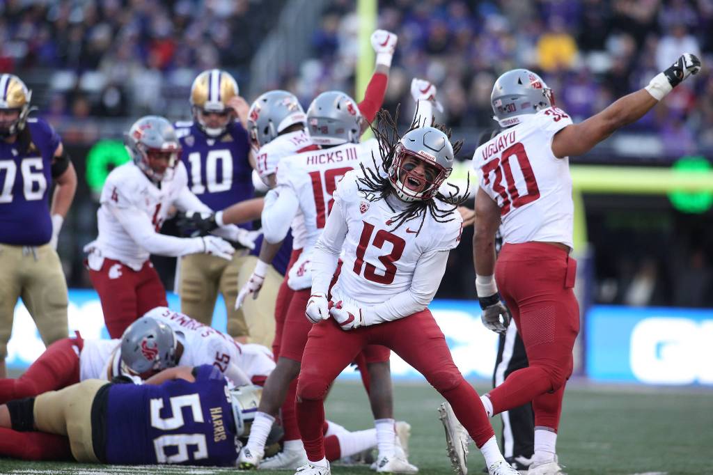 Washington State Cougars linebacker Jahad Woods (13) celebrates a turnover by the Huskies as the Washington State University Cougars lost 31-13 to the University of Washington Huskies in the 112th Apple Cup at Husky Stadium on Friday, Nov. 29, 2019 in Seattle, Wash. (Andy Bronson / The Herald)