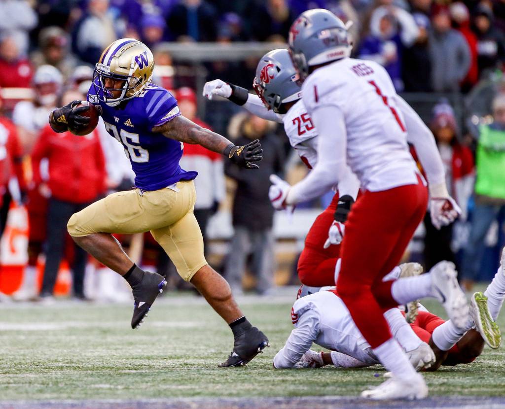 Washington Huskies running back Salvon Ahmed (26) evades the Washington State Cougars defensive for yards during the 112th Apple Cup Friday afternoon at Alaska Airlines at Husky Stadium on November 29, 2019. The Huskies won 31-13. (Kevin Clark / The Herald)