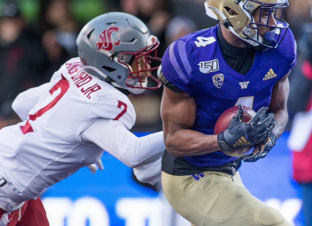 Washington Huskies wide receiver Terrell Bynum (4) hauls in a touchdown pass in the end zone as the Washington State University Cougars lost to the University of Washington Huskies 31-13 in the 112th Apple Cup at Husky Stadium on Friday, Nov. 29, 2019 in Seattle, Wash. (Andy Bronson / The Herald)