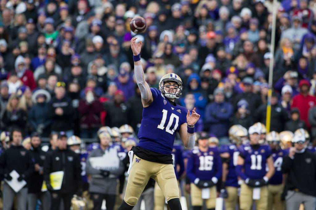 Washington quarterback Jacob Eason throws a second-quarter touchdown pass. (Andy Bronson / The Herald)