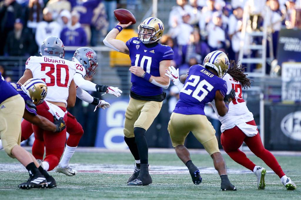 Washington Huskies quarterback Jacob Eason (10) throws from the pocket against the Washington State Cougars during the 112th Apple Cup Friday afternoon at Alaska Airlines at Husky Stadium on November 29, 2019. The Huskies won 31-13. (Kevin Clark / The Herald)