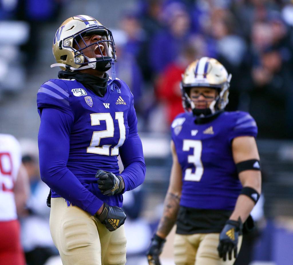 Washington defensive back Dominique Hampton (left) celebrates one of the Huskies five sacks. (Kevin Clark / The Herald)