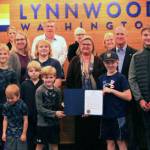Employee award winner Dale Schlack, Lynnwood police chaplain, is pictured with his family and Mayor Nicola Smith. (City of Lynnwood)