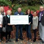 Snohomish Education Foundation board members and school leaders hold up a check for $21,000, which will go toward the Snohomish School Districts Summer Science and Arts Academy. (Snohomish Education Foundation)