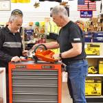 Dunlap Industrial General Manager Rich Barnett (right) and sales associate Doug Dowd check out a new Husqvarna diamond blade power cut cordless saw in the store in Everett. Dunlap offers a multitude of commercial grade tools and equipment that help you complete the task at hand on the jobsite or at home.