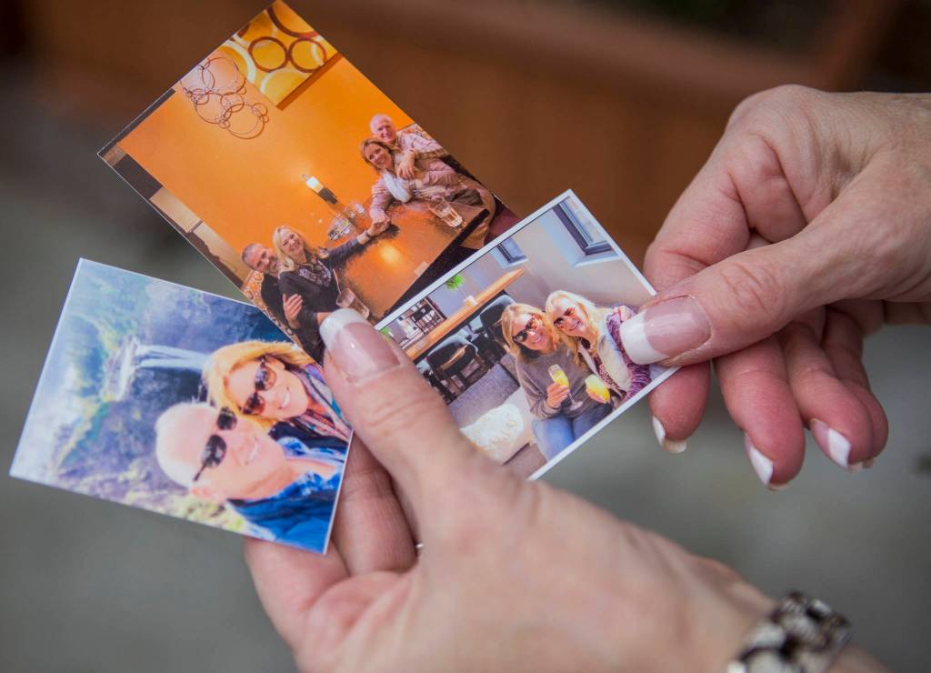 Howell carries around three small photos of herself and her half-sister Linda Holt from the day in October that they met. (Olivia Vanni / The Herald)