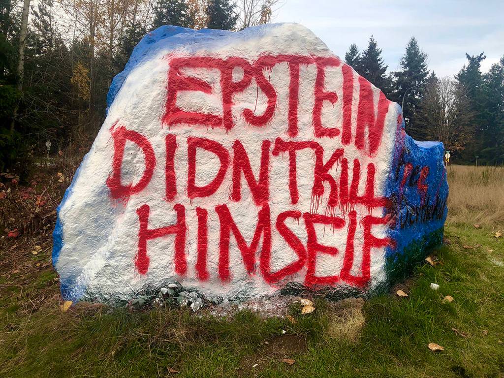 The boulder by Highway 9 in Snohomish, traditionally a canvas for pleasantries, was recently painted with a politically charged message. (Andrea Brown / The Herald)
