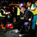 A man in a walker gets medical attention from MercyWatch volunteers Dr. Jimmy Grierson (right) and nurse Gail Pyper while medical scribe Amanda Dahl takes down information. (Dan Bates / The Herald)