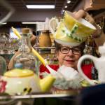 Volunteer Judi Drake dusts around teapots at the Assistance League of Everett on Nov. 18. The gruop sell items at their thrift store and donates the proceeds to Snohomish County families. All 300 people who help out are volunteers. (Andy Bronson / The Herald)