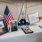 Myra Rintamaki sets up the American Gold Star Mothers remembrance table before the start of the Heros Cafe at the Verdant Community Wellness Center on Nov. 26. (Olivia Vanni / The Herald)