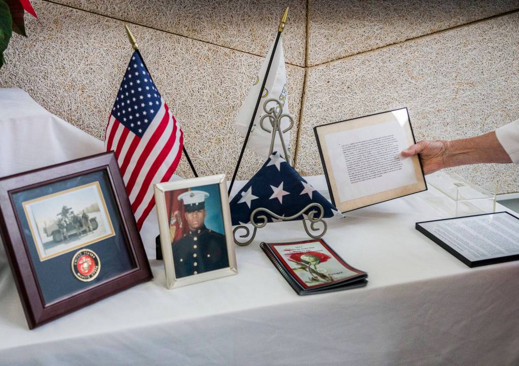 Myra Rintamaki sets up the American Gold Star Mothers remembrance table before the start of the Heros Cafe at the Verdant Community Wellness Center on Nov. 26. (Olivia Vanni / The Herald)