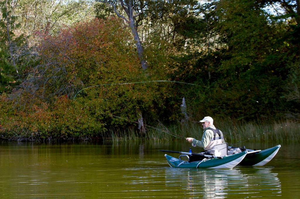 Chuck Morrison of Marysville fishes for trout along the shoreline of Pass Lake. (Mike Benbow)