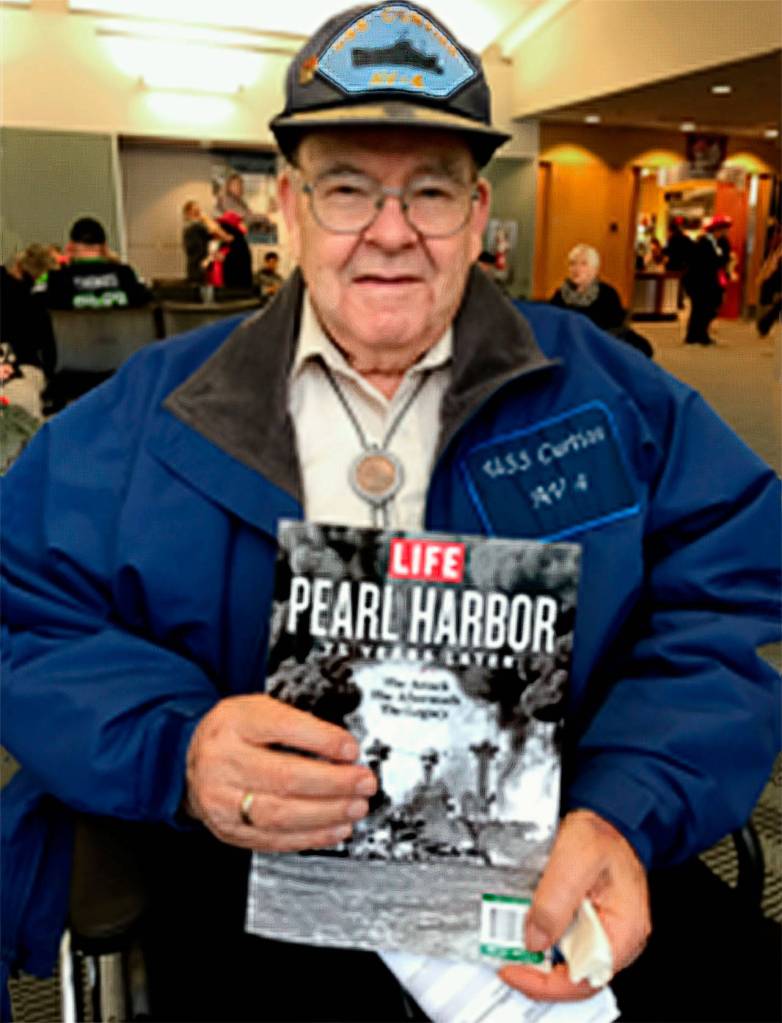Robert Jared Dickson holds a commemorative issue of Life magazine during his 2016 trip to Hawaii for the 75th anniversary of the 1941 attack on Pearl Harbor. The Arlington man, who was a 19-year-old sailor aboard the USS Curtiss that infamous day, died Oct. 22 at age 98. (Courtesy Dickson family)