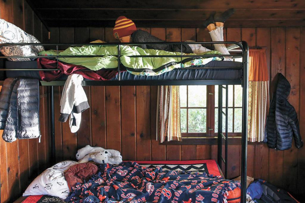 Emma Layton relaxes on her bunk at Cama Beach Historical Park. (Kevin Clark / The Herald)