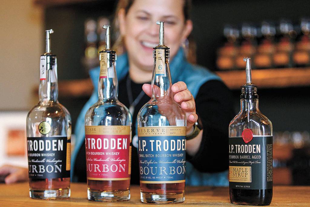 Mara Funk offers a bourbon tasting at JP Trodden in Maltby. (Kevin Clark / The Herald)