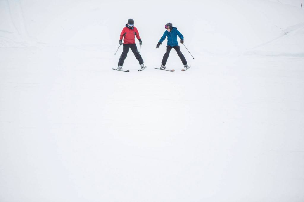 Ski instructor Doug Lewis (right) helps longtime snowboarder Ian Gaweda learn the basics of skiing on opening day at Stevens Pass on Wednesday. (Olivia Vanni / The Herald)
