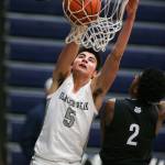 Glacier Peaks Tucker Molina slams dunks on West Seattles Abdirahman Jama as Glacier Peak led West Seattle at the half in a season-opening non-league matchup on Tuesday in Snohomish. (Andy Bronson / The Herald)