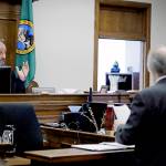 King County Judge Marshall Ferguson listens as Alan Copsey, an associate solicitor general of the state of Washington, speaks during a King County Superior Court hearing on Tuesday in Seattle. Lawyers for cities and counties across Washington state were in court to ask Ferguson to block Tim Eymans $30 I-976 car tab measure from taking effect. (AP Photo/Ted S. Warren, file)