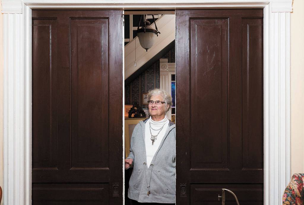 Lisa Pickford shows off a pair of sliding doors in Snohomishs historic Hensel House, built in 1890. (Andy Bronson / The Herald)