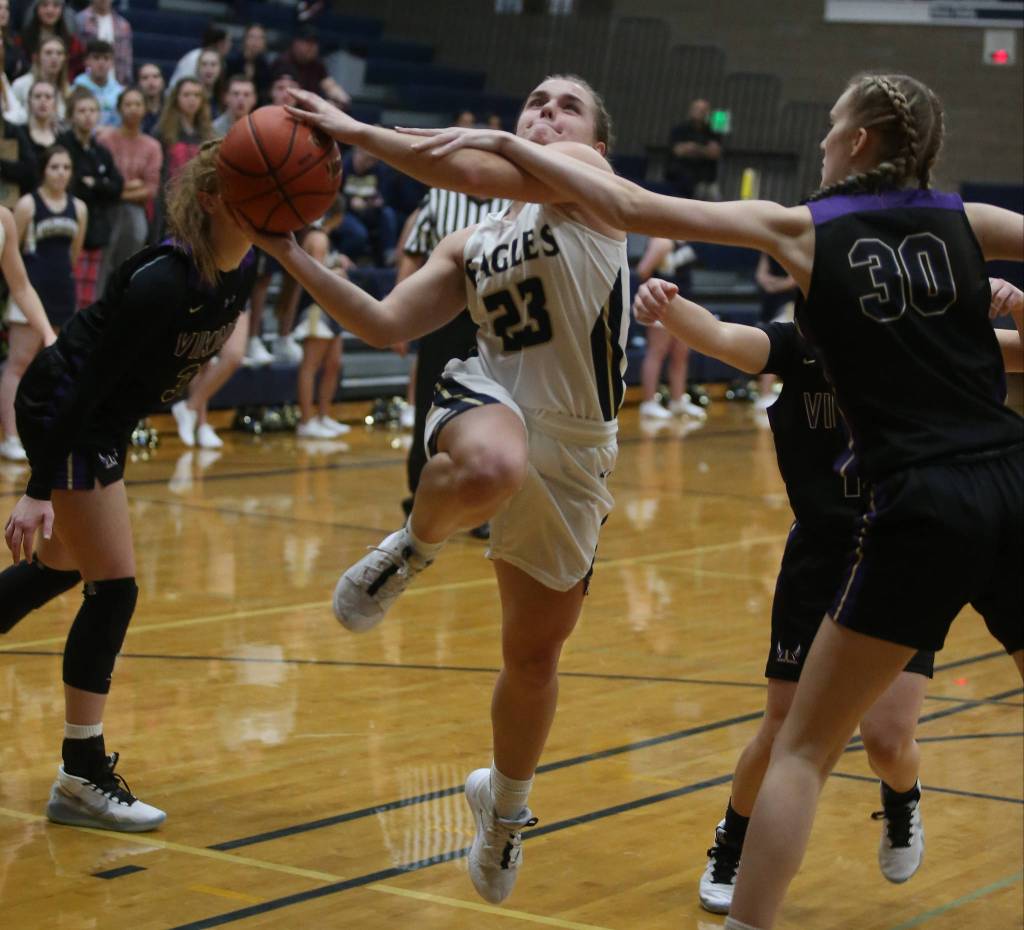 Arlingtons Allison DeBerry is fouled as she drives to the basket. The Arlington Eagles lost to the Lake Stevens Vikings 57-54 in a girls basketball game on Friday, Dec. 6, 2019 in Arlington, Wash. (Andy Bronson / The Herald)                                Arlingtons Allison DeBerry is fouled as she drives to the basket. The Arlington Eagles lost to the Lake Stevens Vikings 57-54 in a girls basketball game on Friday, Dec. 6, 2019 in Arlington, Wash. (Andy Bronson / The Herald)