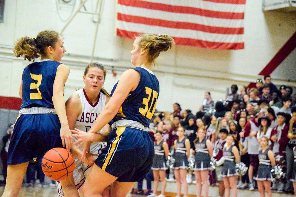 Cascades Taylor Maynard (middle) tries to dribble through Everetts Emma Weir (3) and Caroline Jameson (30) during the city rivals annual BruGull Fest game Friday at Cascade High School in Everett. (Katie Webber / The Herald)