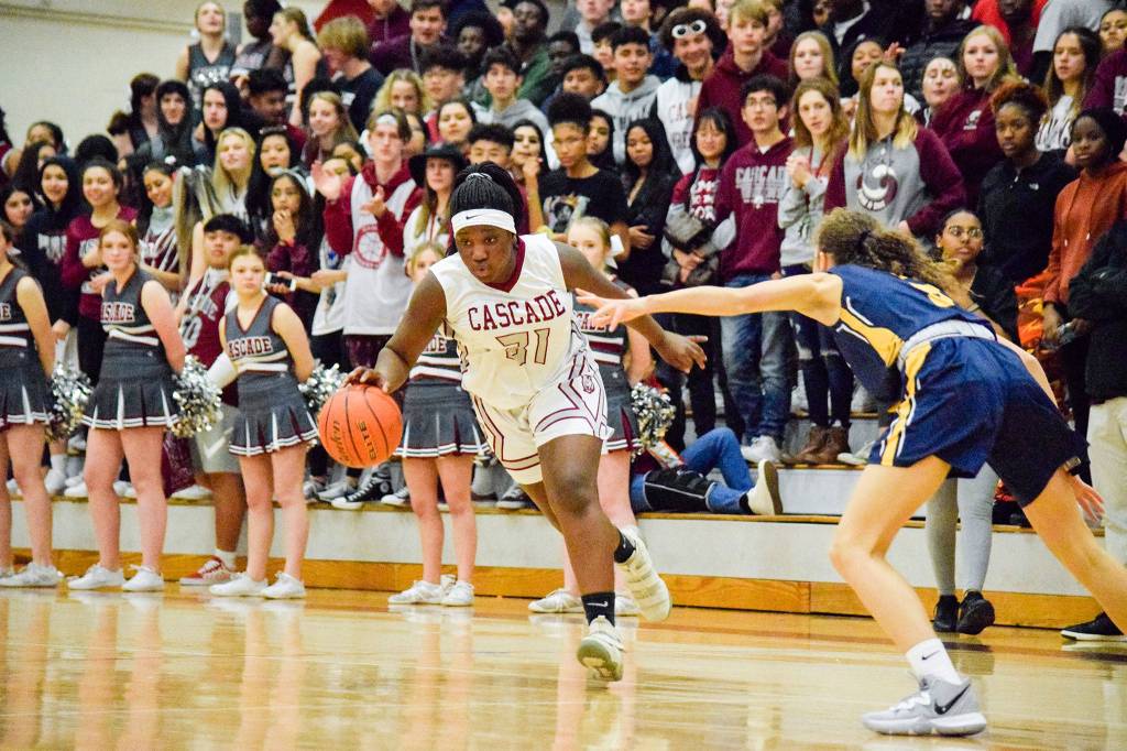 Cascades Mariam Sylla (left) dribbles past Everetts Emma Weir during the city rivals annual BruGull Fest game Friday at Cascade High School in Everett. (Katie Webber / The Herald)