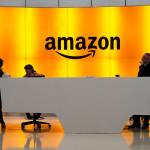 In this Feb. 14 photo, people stand in the lobby for Amazon offices in New York. (AP Photo/Mark Lennihan, File)
