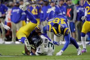 Marcio Jose Sanchez / Associated Press                                Seattle Seahawks quarterback Russell Wilson (3) is tackled by Los Angeles Rams linebackers Obo Okoronkwo (left) and Travin Howard during the second half Sundays game in Los Angeles.