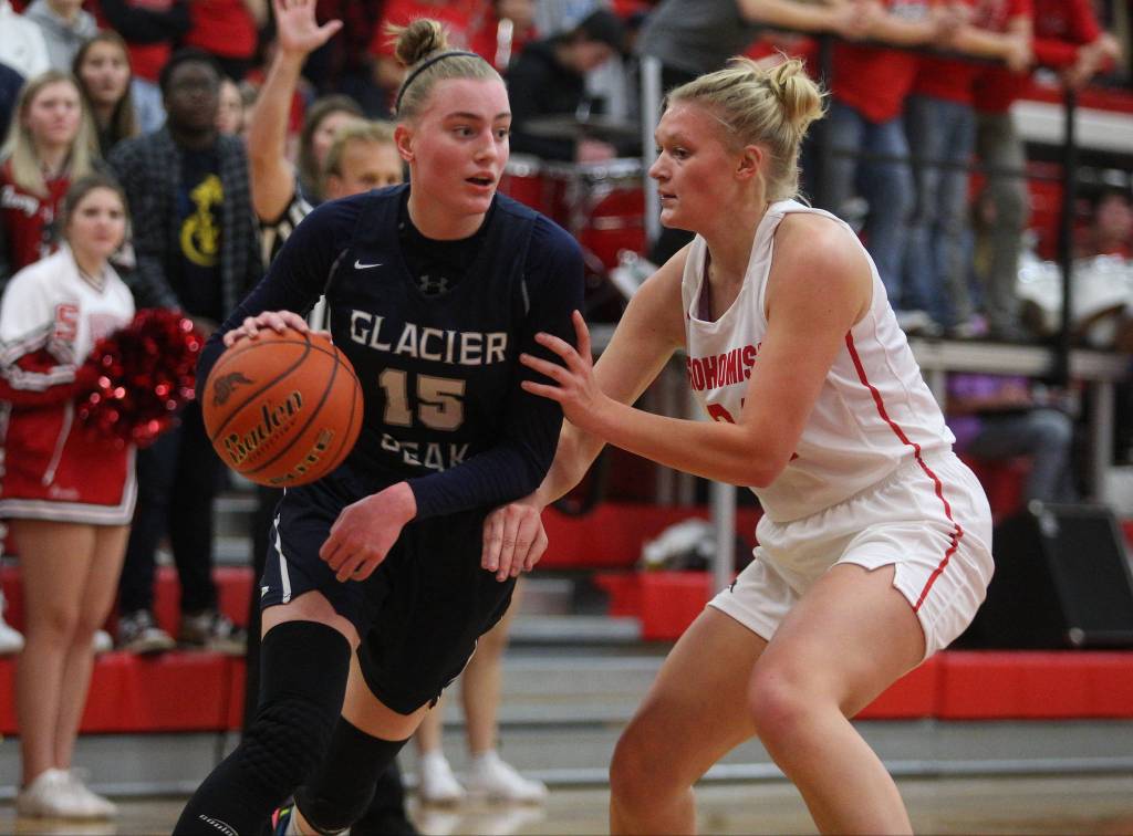 Glacier Peaks Madison Rubino drives around Snohomishs Kaylin Beckman in Glacier Peaks 50-39 win over rival Snohomish in a non-league girls basketball game on Monday, Dec. 9, 2019 in Snohomish, Wash. (Andy Bronson / The Herald)