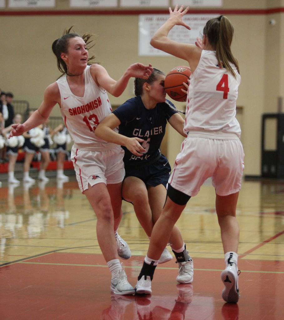 Glacier Peaks Shaylin Sande takes the ball to her face while defended by two Snohomish defenders as Glacier Peak beat rival Snohomish 50-39 in a non-league girls basketball game on Monday, Dec. 9, 2019 in Snohomish, Wash. (Andy Bronson / The Herald)