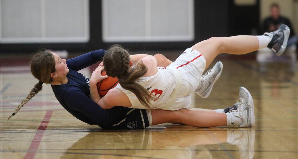 Glacier Peaks Malia Smith and Snohomishs Cheyenne Rodgers battle for the ball as Glacier Peak beat Snohomish 50-39 in a non-league girls basketball game on Monday, Dec. 9, 2019 in Snohomish, Wash. (Andy Bronson / The Herald)