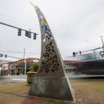 Cars drive by the new Guardians of the Mountain Pass sculpture by Milo White and Jay Bowen on the southeast corner of Main and Lewis streets. The sculpture was commissioned by the city of Monroe. (Olivia Vanni / The Herald)