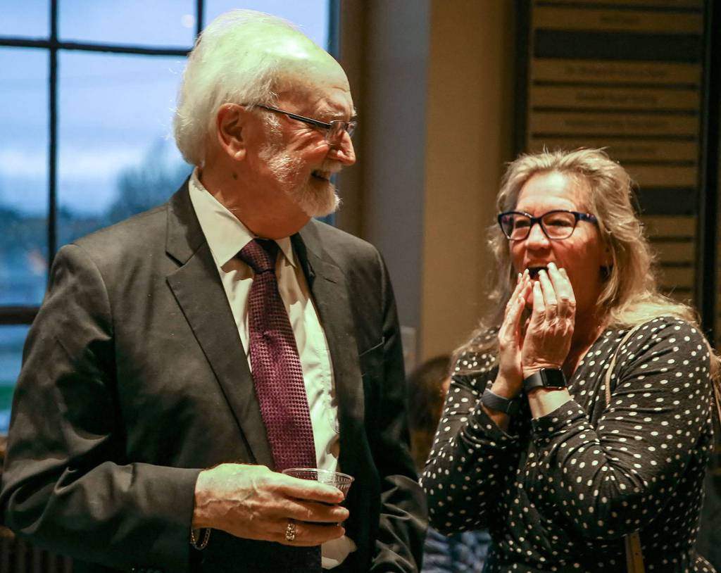 Mayor Dave Earling (left) talks with Councilwoman Adrienne Fraley-Monillas at the Edmonds Center for the Arts on Dec. 12. (Kevin Clark / The Herald)