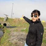 This 2018 photo shows Jaime Jensen, Naval Facilities Engineering Command environmental water program manager, pointing to a creek that flows off base in which toxic firefighting foam chemicals were found. (Laura Guido / Whidbey News-Times)